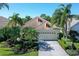 Charming single-story home featuring a paver driveway, two-car garage, and lush landscaping at 6642 Oakland Hills Dr, Lakewood Ranch, FL 34202