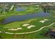 Scenic aerial view of a lush golf course with water hazards and manicured greens in a residential community at 6642 Oakland Hills Dr, Lakewood Ranch, FL 34202