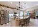 Bright kitchen features an island with seating and granite countertops at 6642 Oakland Hills Dr, Lakewood Ranch, FL 34202