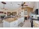 Bright kitchen featuring stainless steel appliances, granite countertops, white cabinetry, and an open layout with an adjacent eating area at 6642 Oakland Hills Dr, Lakewood Ranch, FL 34202