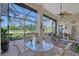 Relaxing screened lanai with comfortable seating, a ceiling fan, and serene golf course views at 6642 Oakland Hills Dr, Lakewood Ranch, FL 34202