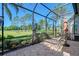 Beautiful screened lanai with comfortable lounge chairs overlooking a scenic golf course at 6642 Oakland Hills Dr, Lakewood Ranch, FL 34202