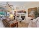 Comfortable living room with a fireplace, plush sofas, decorative art, and ample natural light at 6642 Oakland Hills Dr, Lakewood Ranch, FL 34202