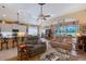 Spacious living area with open kitchen view, ceiling fans, comfortable seating, and elegant decor at 6642 Oakland Hills Dr, Lakewood Ranch, FL 34202