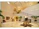 Grand lobby with high ceilings, elegant staircase, marble floors, and decorative plants for a welcoming entrance at 6642 Oakland Hills Dr, Lakewood Ranch, FL 34202