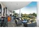 Elegant outdoor lounge area with comfortable seating, a view of the lake, and an iron staircase at 6642 Oakland Hills Dr, Lakewood Ranch, FL 34202
