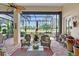 Relaxing screened-in patio boasts brick pavers, comfortable seating, and scenic golf course views at 6642 Oakland Hills Dr, Lakewood Ranch, FL 34202