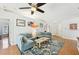 Cozy living room with hardwood floors, a comfortable sofa, and bright decorations at 7006 44Th E Ct, Sarasota, FL 34243