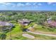Breathtaking aerial view of a home with golf course frontage and surrounding greenery at 7408 S Serenoa Dr, Sarasota, FL 34241