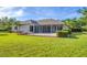 Lush backyard showcases a patio and screened lanai, ideal for outdoor entertaining at 7408 S Serenoa Dr, Sarasota, FL 34241