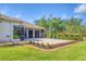 Manicured backyard features a patio, lush greenery, and ample space for outdoor enjoyment at 7408 S Serenoa Dr, Sarasota, FL 34241