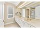 Bright bathroom with a double vanity, tiled floors, and a separate shower at 7408 S Serenoa Dr, Sarasota, FL 34241