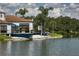 Beautiful view of clubhouse exterior by a lake with landscaping and outdoor patio area at 7408 S Serenoa Dr, Sarasota, FL 34241