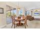 Bright dining area featuring a wooden table, decorative chairs, and sliding doors to the screened porch at 7408 S Serenoa Dr, Sarasota, FL 34241