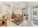 Dining room features a chandelier, decorative rug, and natural light at 7408 S Serenoa Dr, Sarasota, FL 34241
