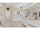 Bright kitchen featuring white cabinetry, modern appliances, and a breakfast bar at 7408 S Serenoa Dr, Sarasota, FL 34241