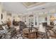 Spacious living room with stylish seating, decorative rug, and view to dining area at 7408 S Serenoa Dr, Sarasota, FL 34241