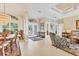 Spacious living room featuring neutral walls, tray ceiling, tile floors, and lots of natural light at 7408 S Serenoa Dr, Sarasota, FL 34241