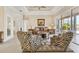 Elegant living room with decorative rug, zebra print chairs, and sliding doors to the patio at 7408 S Serenoa Dr, Sarasota, FL 34241