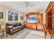 Bright living room featuring wood furniture, large window, and neutral tiled flooring at 7408 S Serenoa Dr, Sarasota, FL 34241