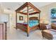 Stately main bedroom with a canopy bed and access to an en-suite bathroom at 7408 S Serenoa Dr, Sarasota, FL 34241