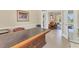 Home office featuring a large desk and view into living area through french doors at 7408 S Serenoa Dr, Sarasota, FL 34241