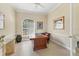 Well-lit office space with a large executive desk, neutral walls, and a bright window at 7408 S Serenoa Dr, Sarasota, FL 34241
