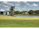 Beautiful putting green overlooking a serene lake, perfect for relaxation and recreation at 7408 S Serenoa Dr, Sarasota, FL 34241