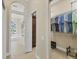 Spacious walk-in closet featuring custom shelving and views into main bathroom at 7408 S Serenoa Dr, Sarasota, FL 34241