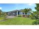 Charming backyard featuring a screened lanai, lush lawn, and thoughtfully designed landscaping at 8110 Trimbelle Ter, Parrish, FL 34219