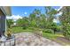 Relaxing backyard patio with lush landscaping, planter box, and stylish outdoor seating at 8110 Trimbelle Ter, Parrish, FL 34219