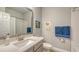 Bright bathroom with a modern vanity, white countertop, and a shower/tub combination for versatile use at 8110 Trimbelle Ter, Parrish, FL 34219