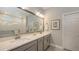 Modern bathroom with double sinks, quartz countertops, tiled floors, and a glass-enclosed shower for a spa-like feel at 8110 Trimbelle Ter, Parrish, FL 34219