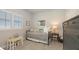 Bright bedroom with a metal bed, and a table/desk with 2 small chairs under a window with blinds at 8110 Trimbelle Ter, Parrish, FL 34219