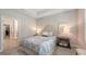 Cozy bedroom with a queen-sized bed, soft lighting, and access to an organized walk-in closet and en-suite bathroom at 8110 Trimbelle Ter, Parrish, FL 34219