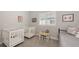Bedroom with 2 white cribs and a full size bed with a table/desk with 2 small chairs under a window at 8110 Trimbelle Ter, Parrish, FL 34219