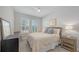 Cozy bedroom with a ceiling fan, plantation shutters, and neutral decor for a comfortable and inviting atmosphere at 8110 Trimbelle Ter, Parrish, FL 34219