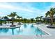Stunning community pool with palm trees, comfortable lounge chairs, and inviting atmosphere at 8110 Trimbelle Ter, Parrish, FL 34219