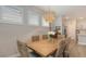 Dining room featuring wooden dining table with seating for six, bright natural light, and modern finishes at 8110 Trimbelle Ter, Parrish, FL 34219