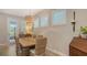 Charming dining room with a wooden table, wicker chairs, a stylish light fixture, and plantation shutters at 8110 Trimbelle Ter, Parrish, FL 34219