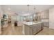 Spacious open floor plan with kitchen island, stainless steel appliances, and living room area at 8110 Trimbelle Ter, Parrish, FL 34219