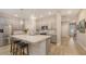 Modern kitchen featuring grey cabinetry, stainless steel appliances, a kitchen island, and pendant lighting at 8110 Trimbelle Ter, Parrish, FL 34219