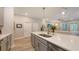 Open kitchen with an island, stainless steel appliances, and a view of the living area at 8110 Trimbelle Ter, Parrish, FL 34219