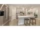 Bright kitchen with grey cabinets, stainless steel appliances, a center island with seating, and modern lighting at 8110 Trimbelle Ter, Parrish, FL 34219
