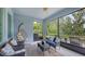 Relaxing screened lanai featuring comfortable seating and serene views of lush landscaping for outdoor enjoyment at 8110 Trimbelle Ter, Parrish, FL 34219