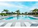 Resort-style pool area with palm trees, lounge chairs, and inviting blue water, perfect for relaxation at 8110 Trimbelle Ter, Parrish, FL 34219