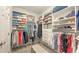 Organized walk-in closet with custom shelving, hanging rods, and a neutral bench for added convenience at 8110 Trimbelle Ter, Parrish, FL 34219