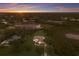 Panoramic aerial showcasing the property's size, location, and spectacular sunset at 8223 Snowy Egret Pl, Bradenton, FL 34202