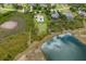 Aerial view of property showcasing the backyard pool, lush lawn, pond and proximity to surrounding neighborhood at 8223 Snowy Egret Pl, Bradenton, FL 34202