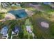 Aerial view of a home with a pool backing onto a pond and surrounded by lush landscaping at 8223 Snowy Egret Pl, Bradenton, FL 34202